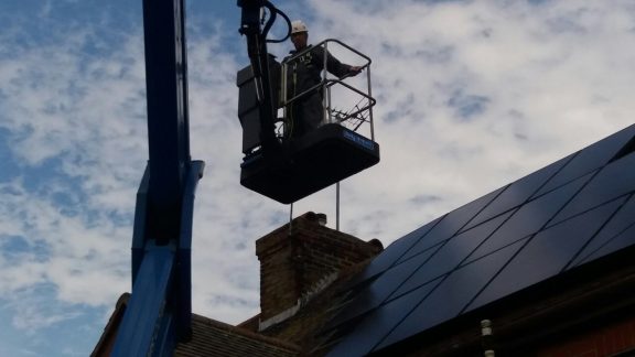 Removing pigeons from under the solar panels using a powered platform.